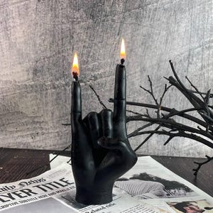 Black Burnin’ Rock candle glowing softly in a modern room