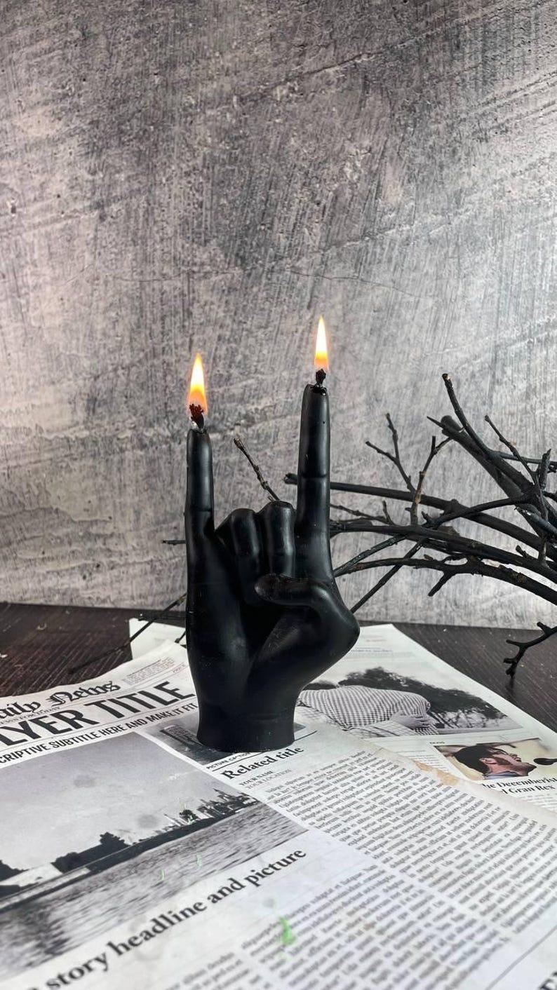 Black Burnin’ Rock candle glowing softly in a modern room