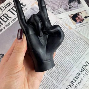 Artisan crafted black wax candle burning in a cozy setting
