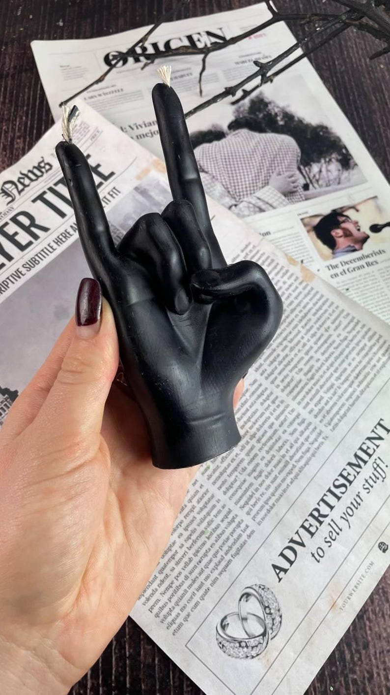 Artisan crafted black wax candle burning in a cozy setting
