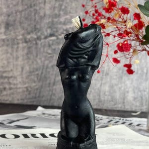 The black candle with silver shimmer reflecting under candlelight
