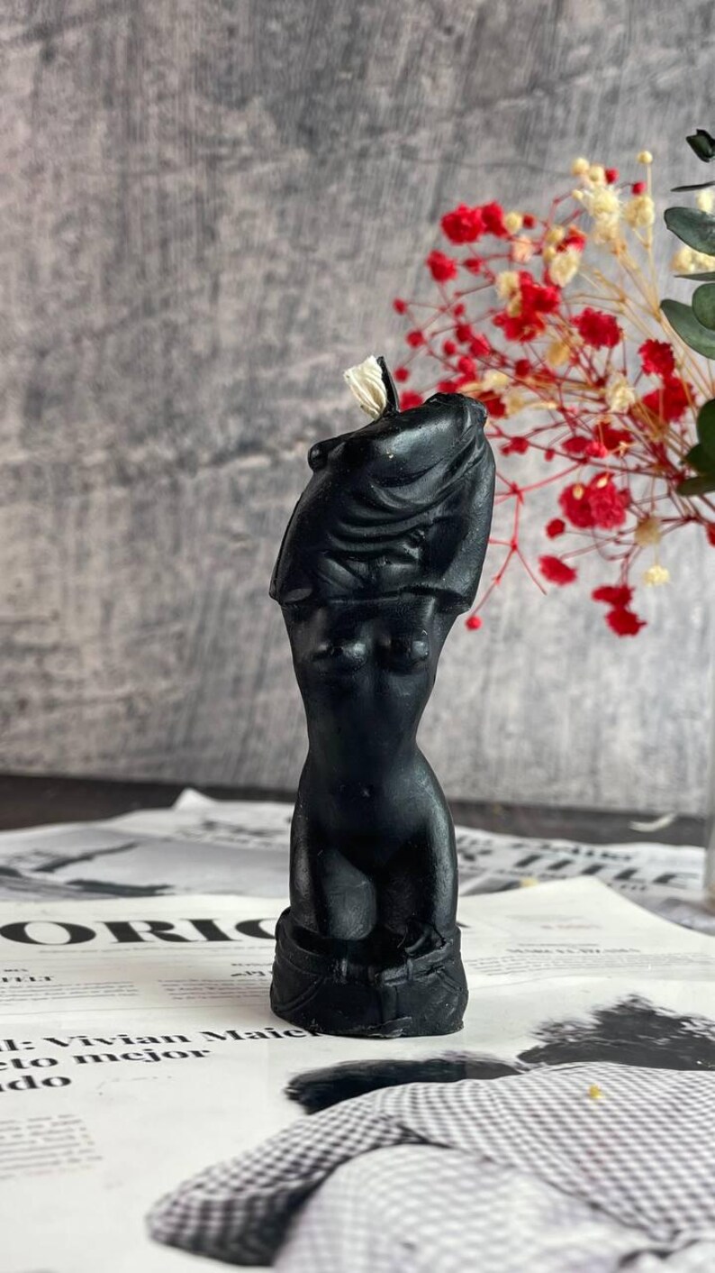 The black candle with silver shimmer reflecting under candlelight
