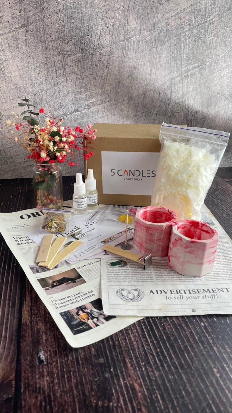 Candle jar filled with soft pink soy wax and floral topping in natural daylight
