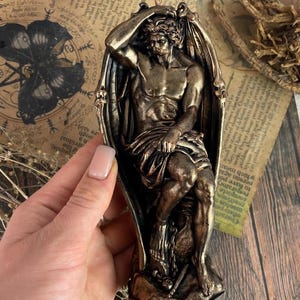Symbolic bronze candle for witchcraft and energy work, handmade with a natural wax base