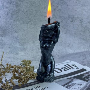One lit candle with soft wax dripping, creating a mesmerizing ambiance