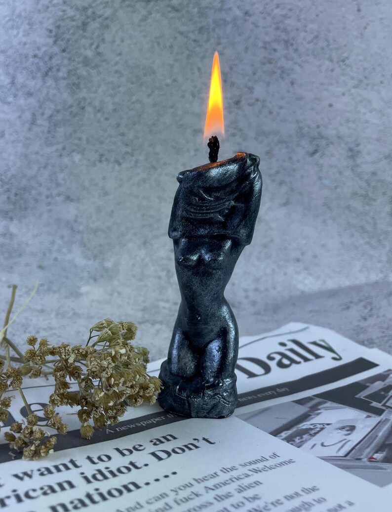 One lit candle with soft wax dripping, creating a mesmerizing ambiance