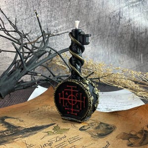 Flat lay of the ritual key candle and parchment with illustrations and symbols