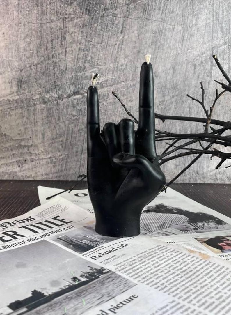Burnin’ Rock candle displayed on an altar surrounded by mystical items