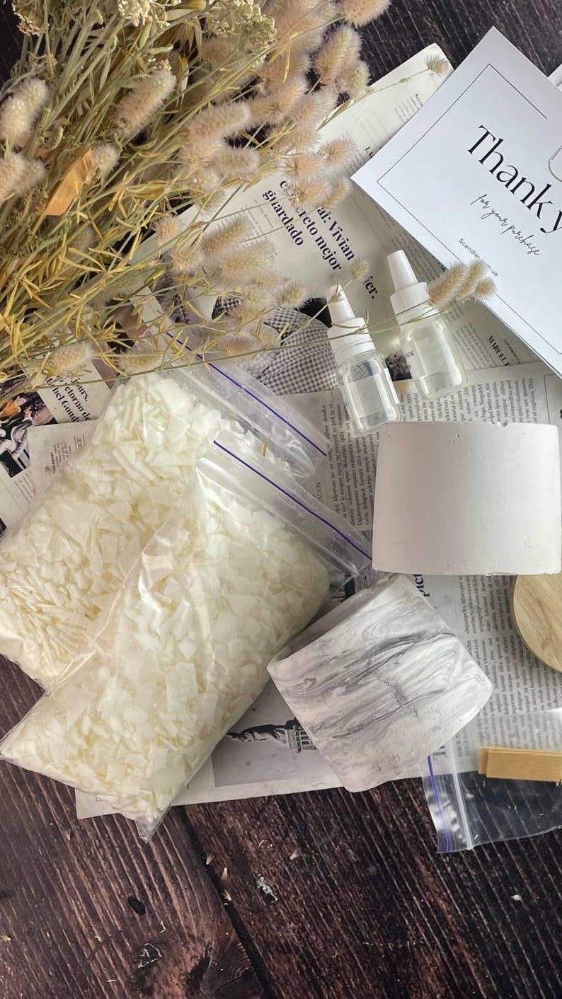 Complete soy wax candle kit with fragrance oils, wicks, jars, and instructions.