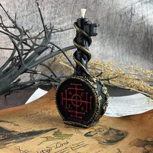 Reverse side of the candle showing intricate red magical sigil engraved in circular base
