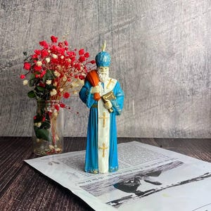Eco-friendly yellow beeswax candle featuring Saint Nicholas design for holiday gifts