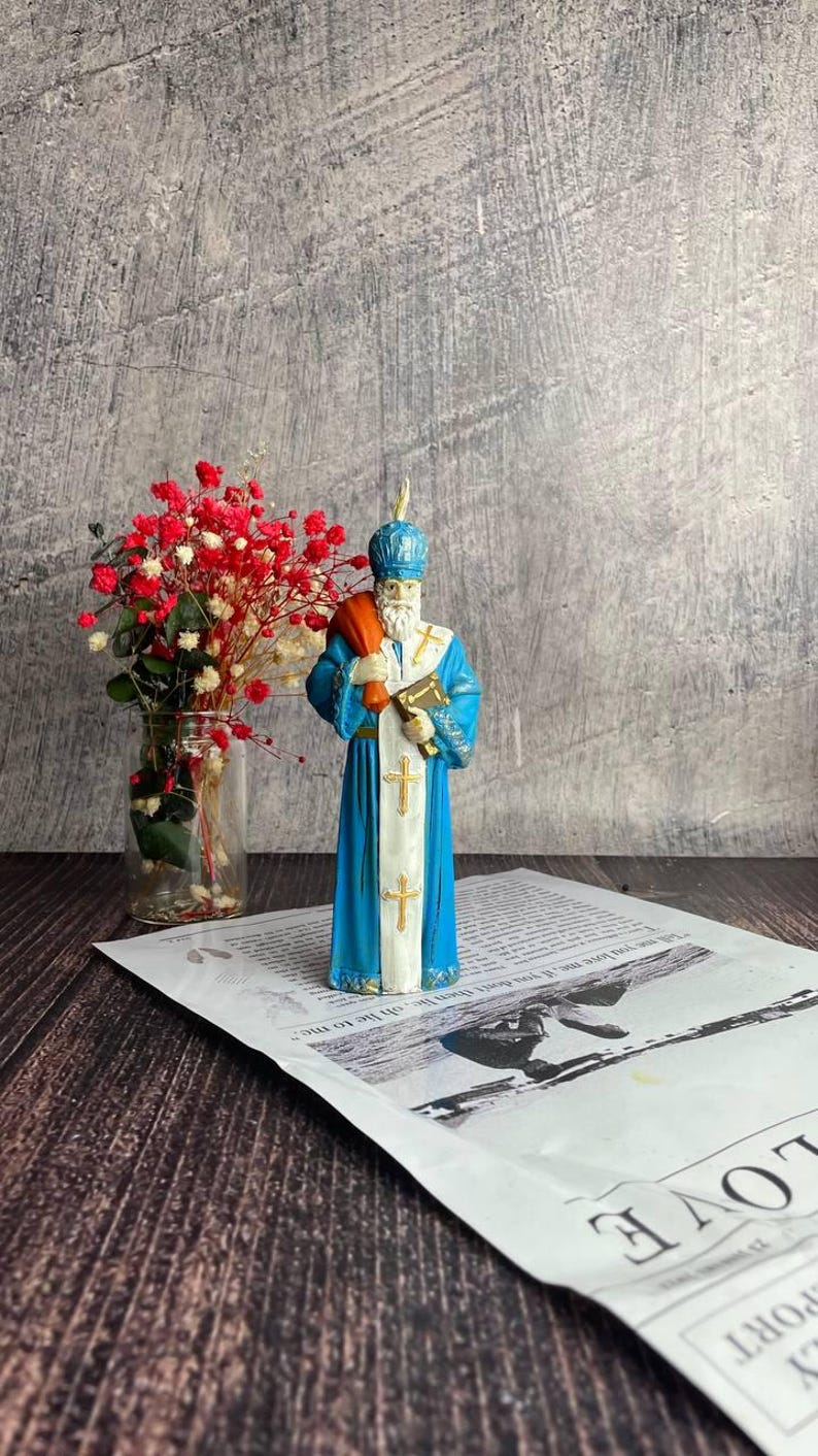 Saint Nicholas candle with intricate design, ideal for winter home decor