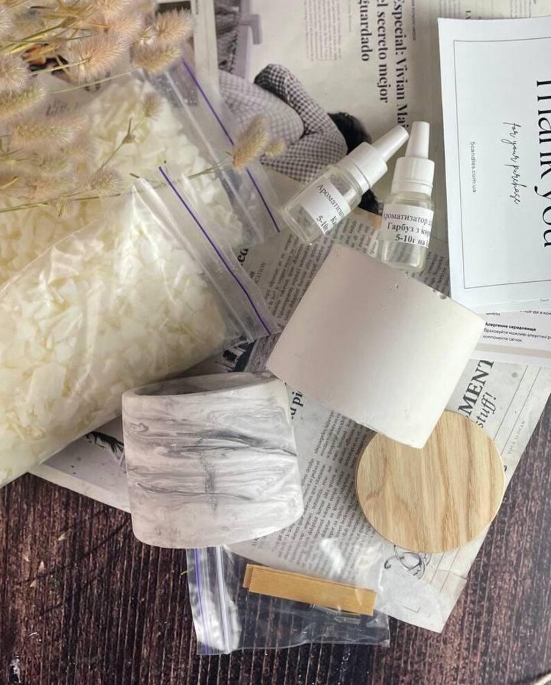 Wooden wick and metal holder set included in DIY candle making kit.