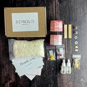 Dye blocks and fragrance oils displayed on a minimal table with kit parts