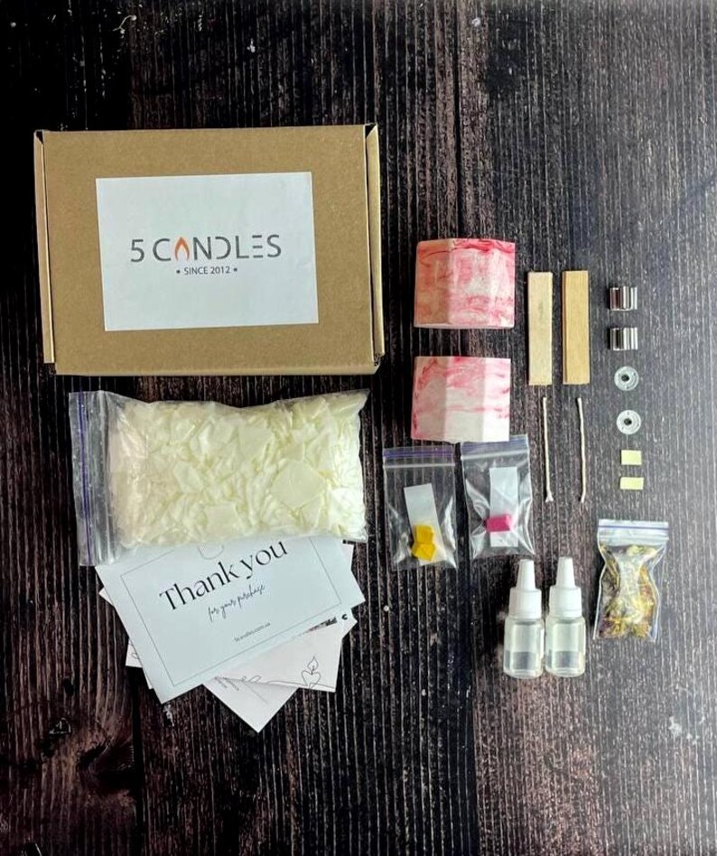 Dye blocks and fragrance oils displayed on a minimal table with kit parts