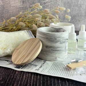 Creative DIY candle kit gift set with marble design jars and wooden wicks.