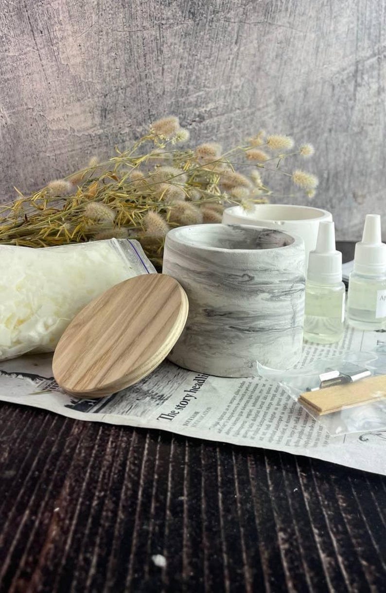 Creative DIY candle kit gift set with marble design jars and wooden wicks.