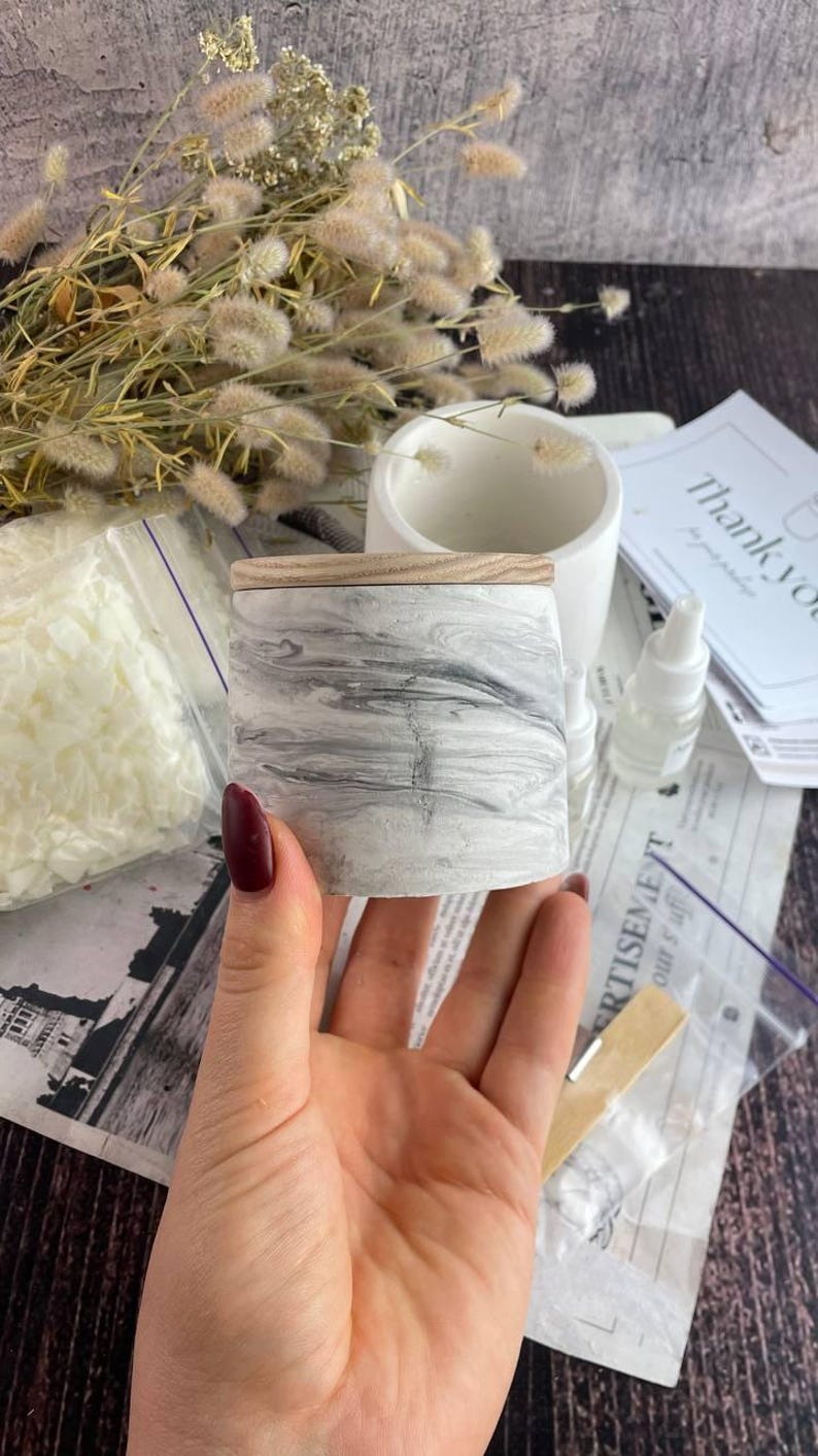 Modern marble candle container with natural wooden lid for handmade candles.