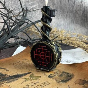 Side view of the wax key candle with visible red sigil and gold detailing
