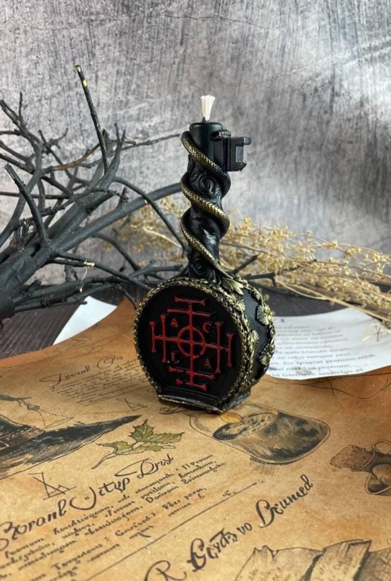 Side view of the wax key candle with visible red sigil and gold detailing