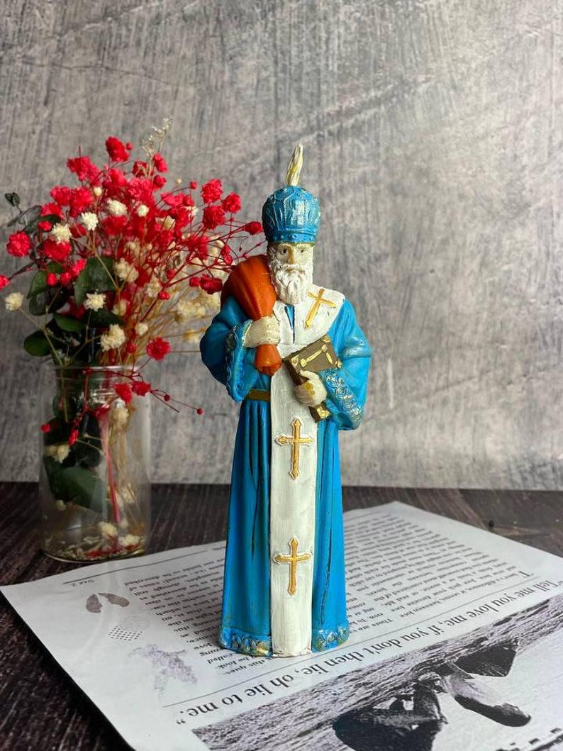 Handmade Saint Nicholas beeswax candle for Christmas decor and festive rituals