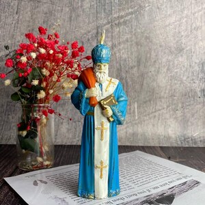 Natural beeswax candle for holiday and religious ceremonies featuring Saint Nicholas