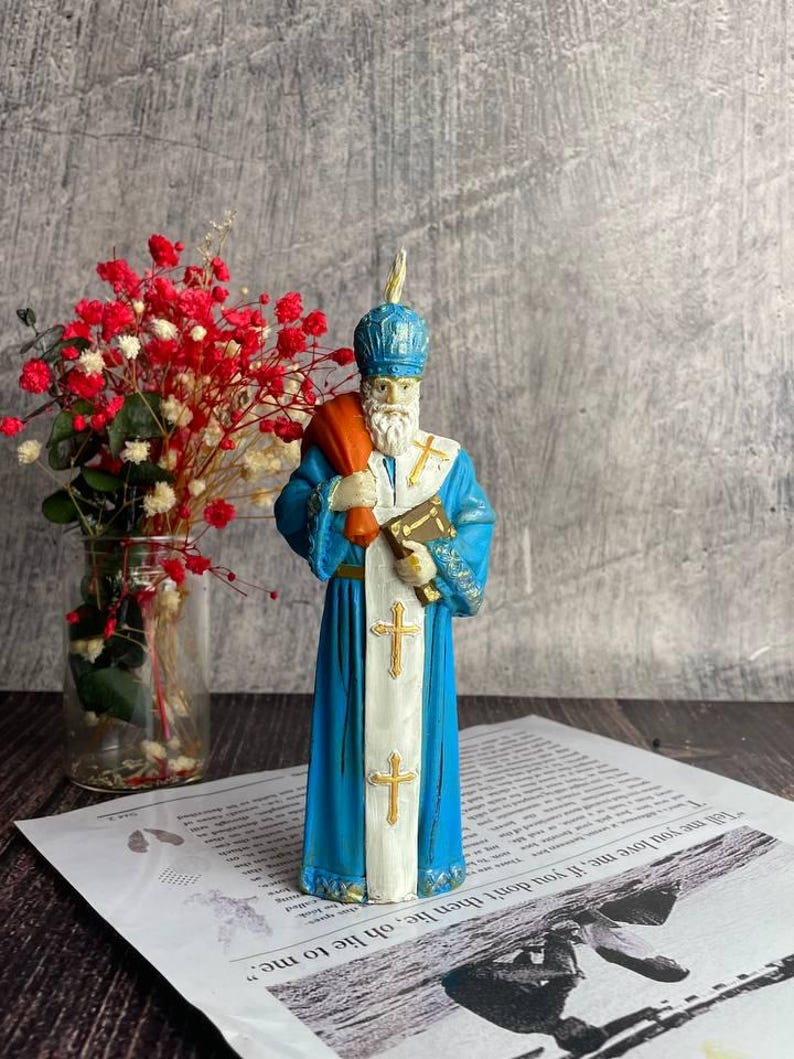 Natural beeswax candle for holiday and religious ceremonies featuring Saint Nicholas