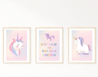 May include: Three framed prints with a unicorn theme. The centre print has a rainbow coloured text that reads "Keep Calm and Ride On A Unicorn". The left and right prints feature a white unicorn with a rainbow mane and horn on a pink and purple gradient background.