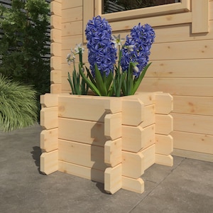 May include: A wooden planter box with a square shape and a light brown finish. The planter is filled with blue hyacinths and white daffodils.