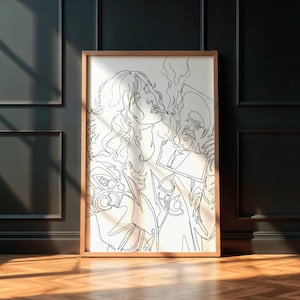 Peut inclure: Une impression d'art encadrée présentant un dessin au trait noir de deux personnes fumant. L'œuvre est de style minimaliste, avec les figures représentées en un trait continu sur fond blanc. Le cadre est de couleur marron clair.