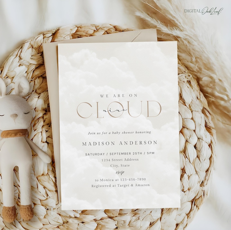 May include: A white baby shower invitation with a watercolor cloud background. The text reads "We are on cloud nine" in a brown font. The invitation includes the name "Madison Anderson", the date "Saturday, September 25th, 5PM", an address, and RSVP information.