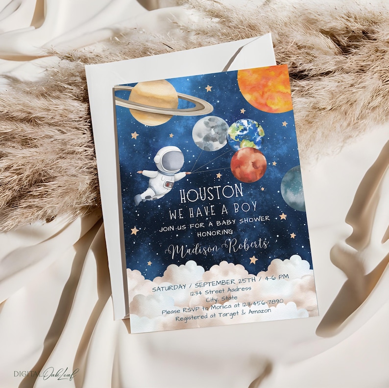 May include: A blue and gold baby shower invitation with a cartoon astronaut holding balloons shaped like planets. The text reads "Houston, We Have A Boy" and includes the baby's name, Madison Roberts, and the date and time of the shower.