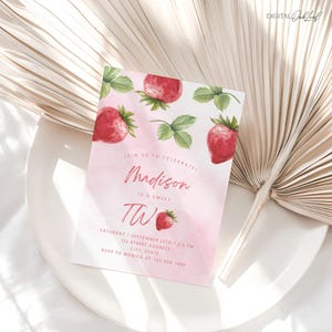 May include: Pink and red watercolor birthday invitation with strawberries and the text "Join us to celebrate! Madison is a sweet Two. Saturday, September 25th / 2-3 PM. 123 Street Address, City, State. RSVP to Monica at 123-456-7890."