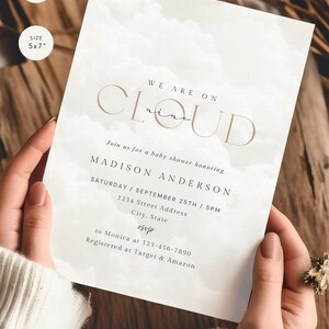 May include: A white baby shower invitation with a watercolor cloud background. The text reads "We are on Cloud nine" and includes the name "Madison Anderson", the date and time of the shower, and the address. The invitation also includes RSVP information and registry details.