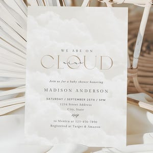 May include: A white baby shower invitation with a watercolor background. The text reads "We are on Cloud Nine" and includes the name Madison Anderson, the date and time of the shower, the address, and RSVP information.