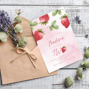 May include: Pink and white birthday invitation with a watercolor strawberry design. The invitation says "Join us to celebrate! Madison is a sweet two" and includes the date, time, and RSVP information.
