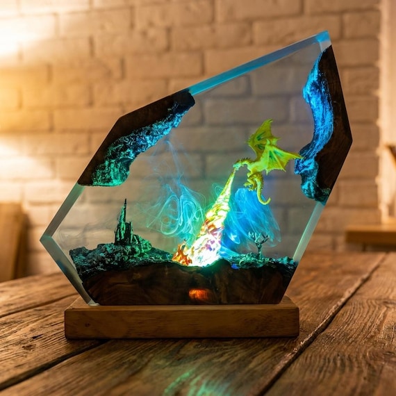 A fire-breathing dragon frozen mid-roar inside an LED-lit epoxy resin diorama lamp — handmade fantasy desk art that doubles as a night light.