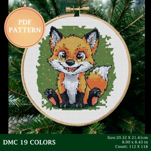 May include: A cross-stitch pattern featuring a cartoon fox with a green background. The pattern is in a round embroidery hoop and includes the text "PDF PATTERN" and "DMC 19 COLORS". The pattern is 8 inches by 8 inches and has a count of 112 by 118.