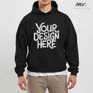 May include: A black hooded sweatshirt with the text "YOUR DESIGN HERE" printed in white on the front.