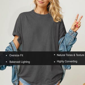 May include: A dark gray oversized t-shirt with rolled sleeves. The shirt is paired with a denim jacket. Text on the image reads: Oversize Fit, Natural Tones & Texture, Balanced Lighting, and Highly Converting.