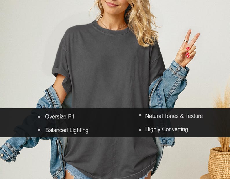 May include: A dark gray oversized t-shirt with rolled sleeves. The shirt is paired with a denim jacket. Text on the image reads: Oversize Fit, Natural Tones & Texture, Balanced Lighting, and Highly Converting.