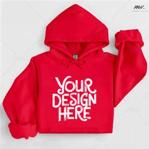 May include: A red hooded sweatshirt with the text "YOUR DESIGN HERE" in white. The sweatshirt has a drawstring hood, long sleeves, and a front pocket. The sleeves are cuffed at the wrists.