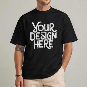 May include: A black t-shirt with the text "Your Design Here" printed in white on the front.