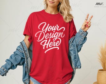 May include: A red t-shirt with the text "Your Design Here" in white script. The model is wearing a denim jacket over the shirt. The image is taken in a studio setting.