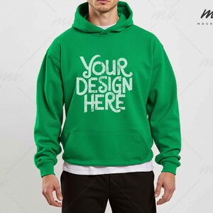 May include: A green hooded sweatshirt with the text "YOUR DESIGN HERE" printed on the front.