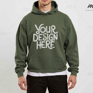 May include: A green hooded sweatshirt with the text "YOUR DESIGN HERE" in white on the front.