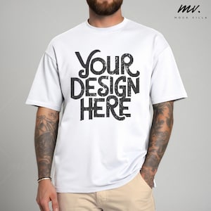 May include: White t-shirt with the text "YOUR DESIGN HERE" printed in black on the front.