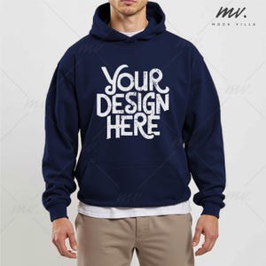 May include: A navy blue hooded sweatshirt with the text "YOUR DESIGN HERE" in white lettering. The sweatshirt has a pouch pocket and a drawstring hood.