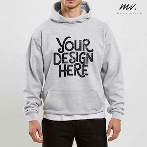 May include: A gray hooded sweatshirt with the text "YOUR DESIGN HERE" printed on the front.