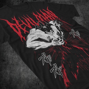 May include: Black t-shirt with a white and red graphic print of a character from the anime "Devilman" with the text "Devilman" in red and the Japanese text "Akuma" in white.